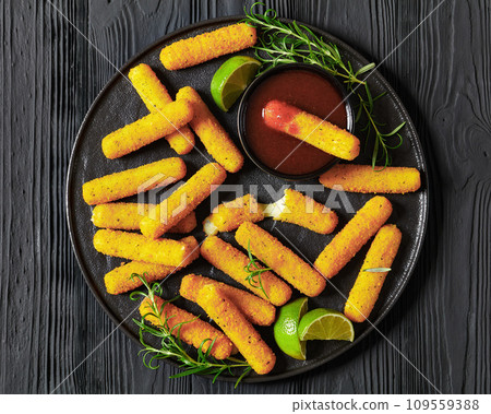 fried mozzarella sticks with sauce on black plate fried mozzarella sticks with sauce on black plate 109559388