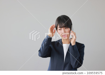 A woman with a tense expression after being yelled at on the phone 1 A woman with a tense expression after being yelled at on the phone 1 109559575