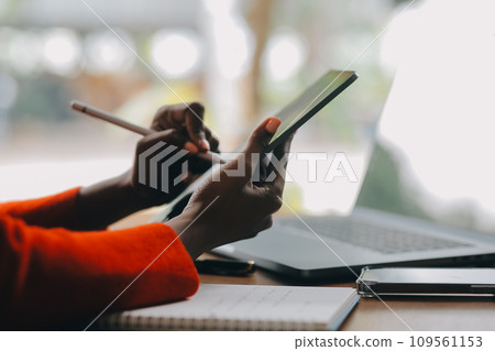 Portrait of Young Asian woman hand freelancer is working her job on computer tablet in modern office. Doing accounting analysis report real estate investment data, Financial and tax systems concept. 109561153
