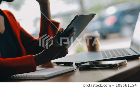 Portrait of Young Asian woman hand freelancer is working her job on computer tablet in modern office. Doing accounting analysis report real estate investment data, Financial and tax systems concept. Portrait of Young Asian woman hand freelancer is working her job on computer tablet in modern office. Doing accounting analysis report real estate investment data, Financial and tax systems concept. 109561154