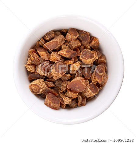 Dried cut red Korean ginseng root in a white bowl. Panax ginseng, also known as Asian or Chinese ginseng. Used as an herb in folk medicine, consumed by adults to improve memory, cognition and others. Dried cut red Korean ginseng root in a white bowl. Panax ginseng, also known as Asian or Chinese ginseng. Used as an herb in folk medicine, consumed by adults to improve memory, cognition and others. 109561258