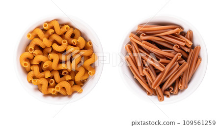 Gluten free cavatappi and casarecce pasta in white bowls. Cavatappi made of red lentil,  chickpea and rice flour. The corkscrew shaped casarecce or also cellentani are made of chickpea and rice flour. 109561259