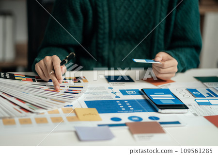 Creative male web designer planning application development for web mobile phone at modern workplace. Creative male web designer planning application development for web mobile phone at modern workplace. 109561285