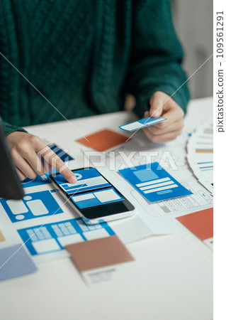 Creative male web designer planning application development for web mobile phone at modern workplace. Creative male web designer planning application development for web mobile phone at modern workplace. 109561291