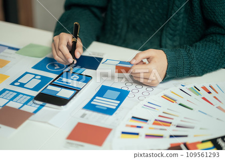 Creative male web designer planning application development for web mobile phone at modern workplace. Creative male web designer planning application development for web mobile phone at modern workplace. 109561293