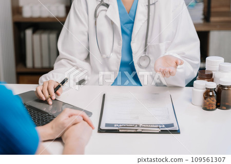 patient filling insurance legal document at appointment with doctor. patient signing medical treatment contract, agreement form for taking medic care service, consultation, therapy patient filling insurance legal document at appointment with doctor. patient signing medical treatment contract, agreement form for taking medic care service, consultation, therapy 109561307