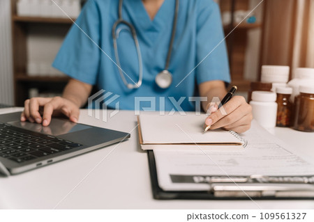 Medical Technology Concepts. Medical students use laptop computer to search for information in a modern office in the morning at the desk. 109561327