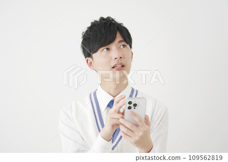 High school boy thinking while holding a smartphone, white background 109562819
