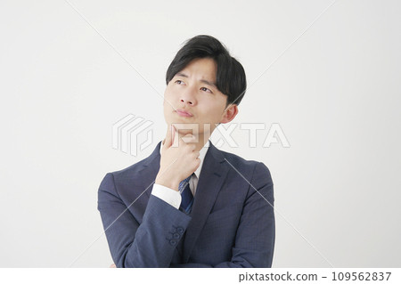 Thinking businessman white background Thinking businessman white background 109562837