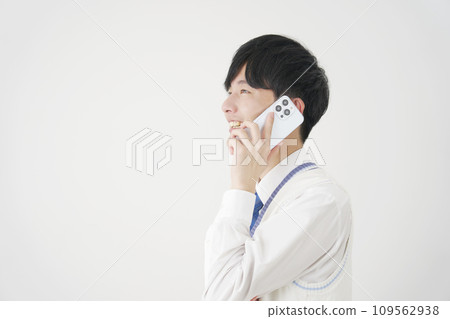 High school boy calling on smartphone, white background High school boy calling on smartphone, white background 109562938