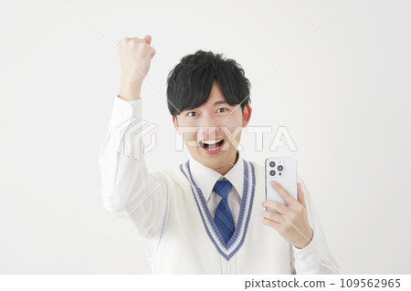 A high school boy doing a fist pump while holding a smartphone, white background 109562965