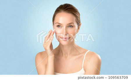 Woman applying cream on face Woman applying cream on face 109563709