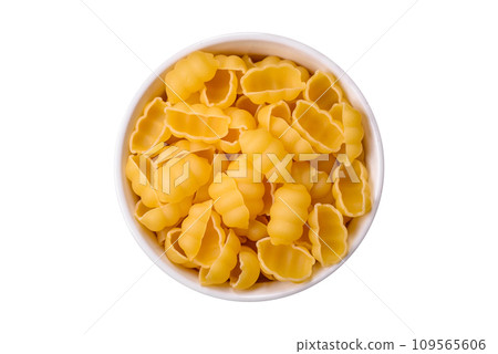 Raw durum wheat gnocchi pasta with salt and spices in a ceramic plate 109565606