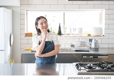 A woman thinking in the kitchen A woman thinking in the kitchen 109566205
