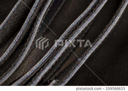 the seam at the junction of two pieces of black leather 109566633