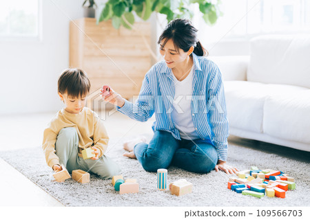 child and mother playing with toys 109566703