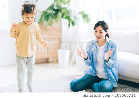 Children playing with toys and mother watching over them Children playing with toys and mother watching over them 109566711