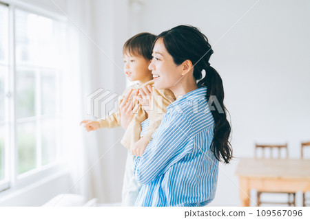 Parent and child hugging each other and looking outside Parent and child hugging each other and looking outside 109567096
