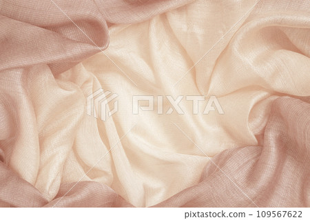 Crumpled silk fabric, peach color, soft texture, pastel textile background 109567622