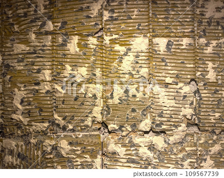 Fragment of an old wall with cracks and holes. Structure of an old wall. Architectural concept for repair, restoration and construction Fragment of an old wall with cracks and holes. Structure of an old wall. Architectural concept for repair, restoration and construction 109567739