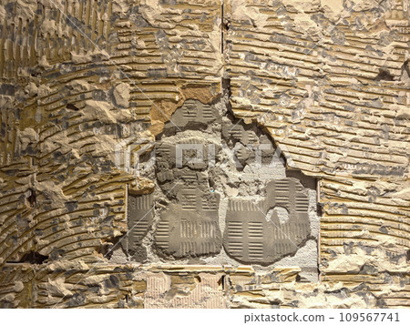 Fragment of an old wall with cracks and holes. Structure of an old wall. Architectural concept for repair, restoration and construction Fragment of an old wall with cracks and holes. Structure of an old wall. Architectural concept for repair, restoration and construction 109567741