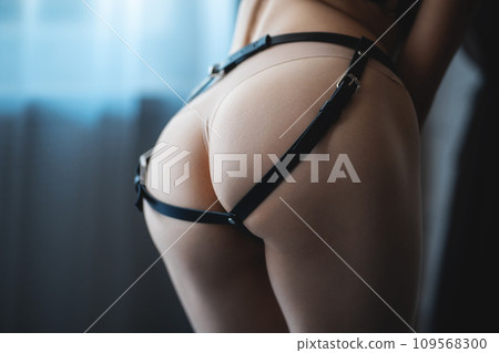 beautiful sexy woman in black leather harness and bondage, sensual female in bdsm seductive lingerie, sex role play 109568300