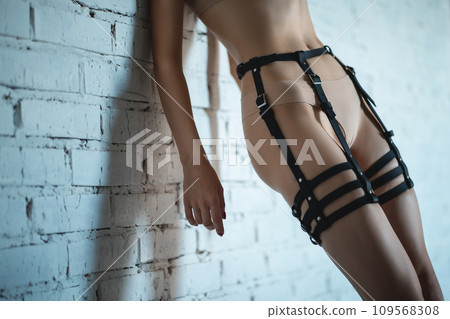 beautiful sexy woman in black leather harness and bondage, sensual female in bdsm seductive lingerie, sex role play beautiful sexy woman in black leather harness and bondage, sensual female in bdsm seductive lingerie, sex role play 109568308