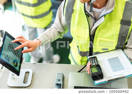 Male worker checking in and out of warehouse, faceless Male worker checking in and out of warehouse, faceless 109568492