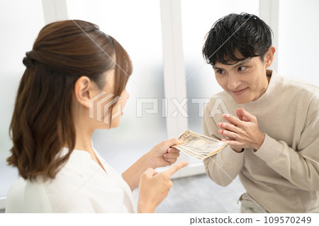 A scene where a husband asks his wife for more pocket money 109570249