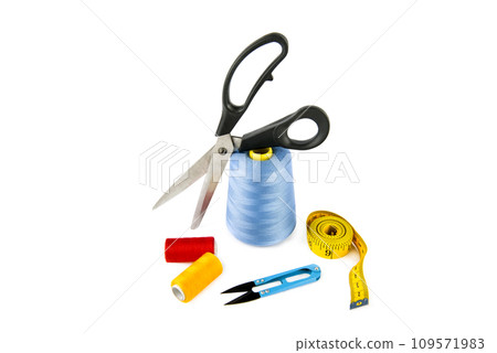 Sewing supplies (thread, scissors and measuring tape) isolated on a white. 109571983