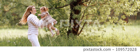 A joyful image of a mother and child in a park A joyful image of a mother and child in a park 109572028