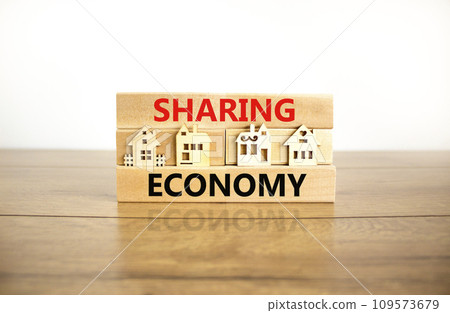 Sharing economy symbol. Concept words Sharing economy on beautiful wooden blocks. Beautiful wooden table white background. House model. Business sharing economy concept. Copy space. Sharing economy symbol. Concept words Sharing economy on beautiful wooden blocks. Beautiful wooden table white background. House model. Business sharing economy concept. Copy space. 109573679