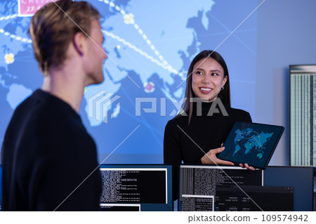 Smiling cyber security team working in a Cyber Security Operations Center SOC to protect systems and technologies Smiling cyber security team working in a Cyber Security Operations Center SOC to protect systems and technologies 109574942