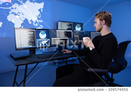 Back View in the Cyber Security Control Center Operator Working. Multiple Screens Showing Technical Data and Alerts. 109574950