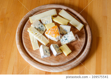Cheese platter with different kinds of cheese on wooden table Cheese platter with different kinds of cheese on wooden table 109575541