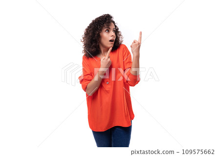 young surprised caucasian lady with curly hair style points finger towards copy space young surprised caucasian lady with curly hair style points finger towards copy space 109575662