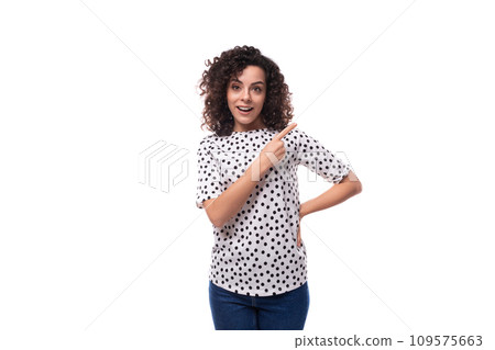 young dark-haired caucasian woman dressed in a blouse points with her hands space for advertising young dark-haired caucasian woman dressed in a blouse points with her hands space for advertising 109575663