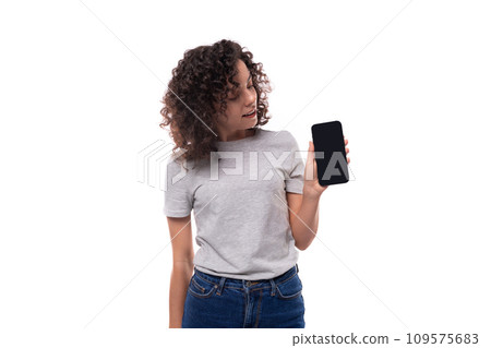well-groomed caucasian young brunette woman with curly hair shows smartphone screen on white well-groomed caucasian young brunette woman with curly hair shows smartphone screen on white 109575683