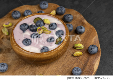 fresh purple and white yogurt with blueberries and blueberry berry flavor fresh purple and white yogurt with blueberries and blueberry berry flavor 109576279