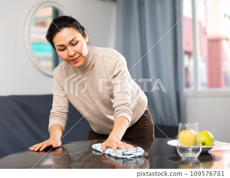 Woman washing table during cleanup 109576781