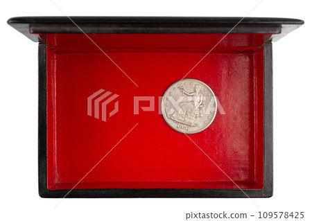 vintage old black and red casket with silver dollar coin 109578425