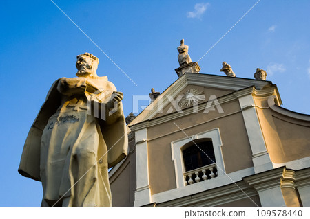 Kamianets-Podilskyi, , Ukraine, 2006. Stone statue of a Catholic saint in front of the Holy Trinity Church of Trinitarian Order. Kamianets-Podilskyi, , Ukraine, 2006. Stone statue of a Catholic saint in front of the Holy Trinity Church of Trinitarian Order. 109578440