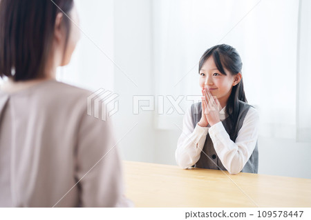 A girl asking her mother for a favor A girl asking her mother for a favor 109578447