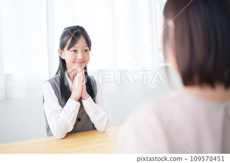 A girl asking her mother for a favor A girl asking her mother for a favor 109578451