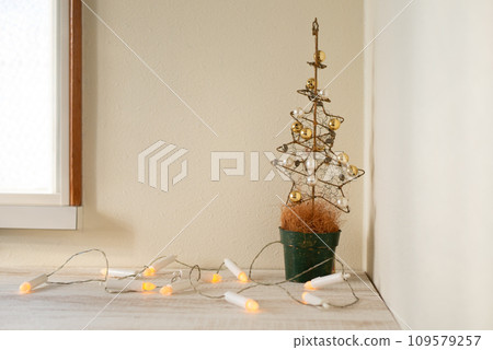 Beautiful golden Christmas tree and candle-shaped lights [Christmas] 109579257