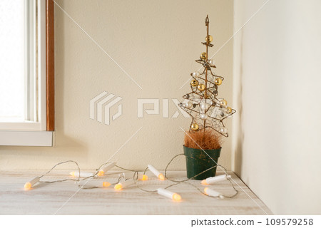 Beautiful golden Christmas tree and candle-shaped lights [Christmas] 109579258