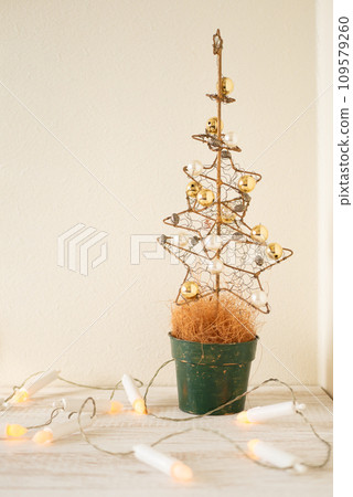 Beautiful golden Christmas tree and candle-shaped lights [Christmas] 109579260