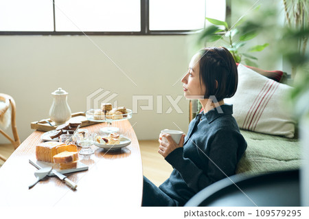 A woman relaxing in the living room 109579295