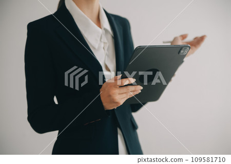 Beautiful female call center operator working on computer in office Beautiful female call center operator working on computer in office 109581710