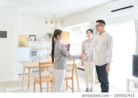 A man and a woman shake hands after closing a real estate deal A man and a woman shake hands after closing a real estate deal 109582433